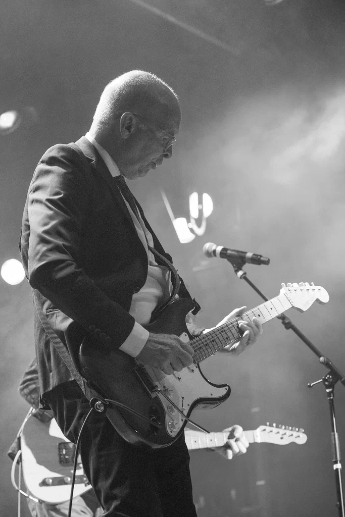 A person playing an electric guitar on stage at JoCo Cruise 2025.