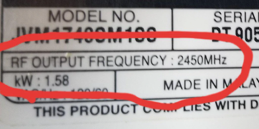 Label with model number, serial number, RF output frequency (2450 MHz), power (1.58 kW), and "Made in Malaysia."