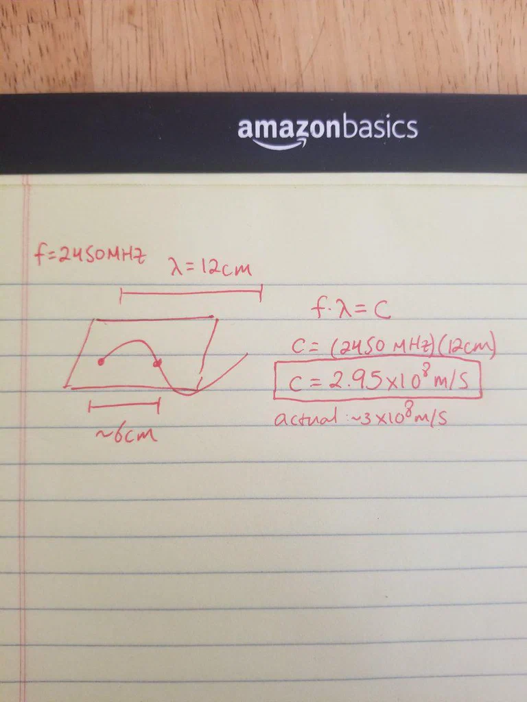 A page of handwritten physics notes with calculations related to wave speed, showing the frequency, wavelength, and speed of a wave, along with a diagram illustrating the wave pattern.
