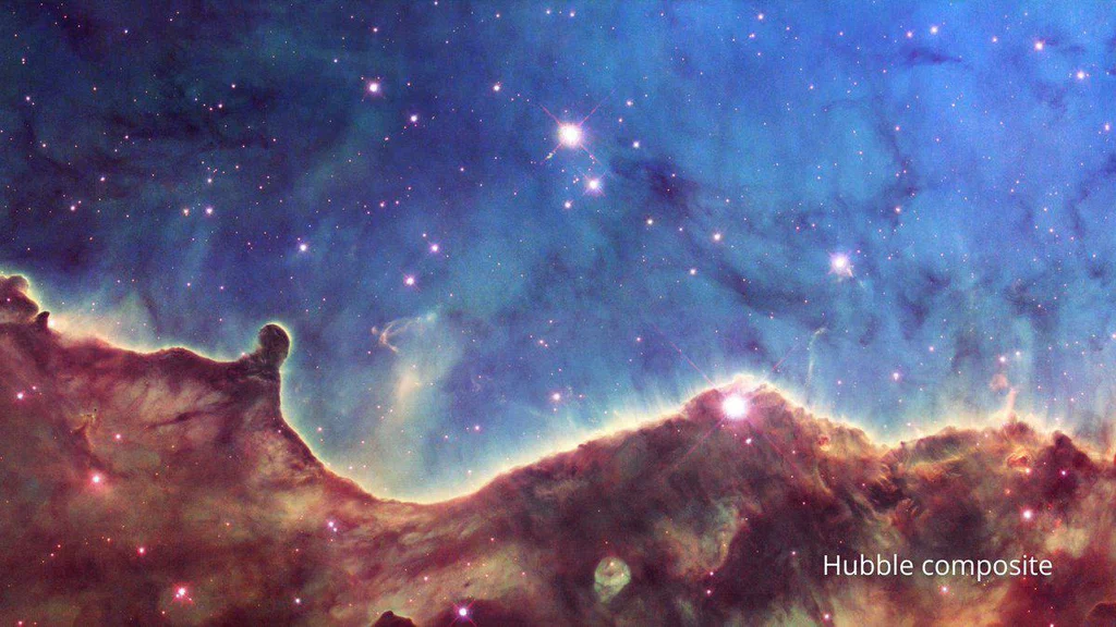 A colorful view of a nebula with numerous stars, featuring a bright central region and clouds of gas and dust in shades of blue, purple, and red.